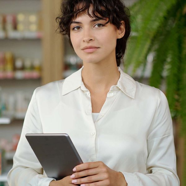 young-elegant-shop-assistant-in-white-shirt-standi-CZS6B23.jpg